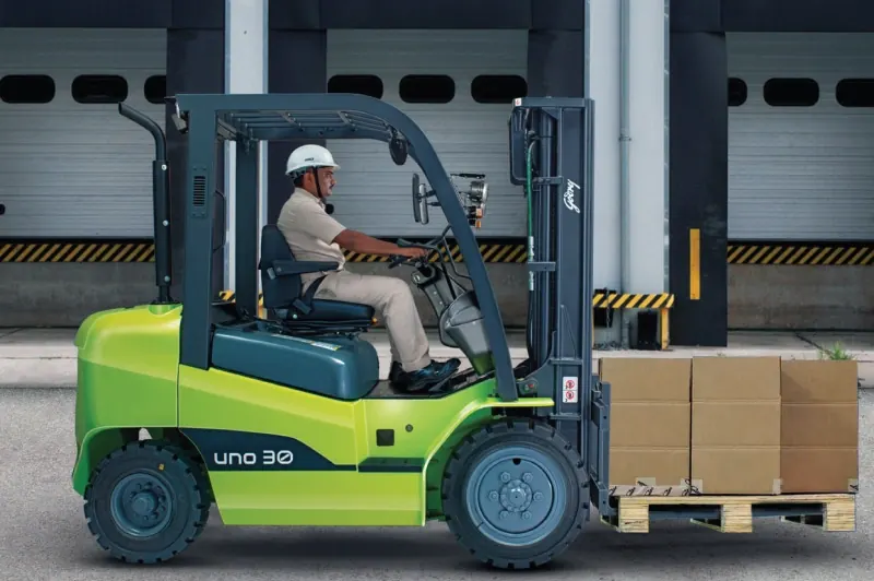 A Godrej UNO 30 forklift with an operator at a loading dock